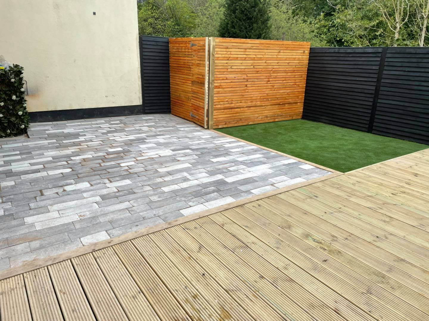 Garden with decking, paving and artificial grass